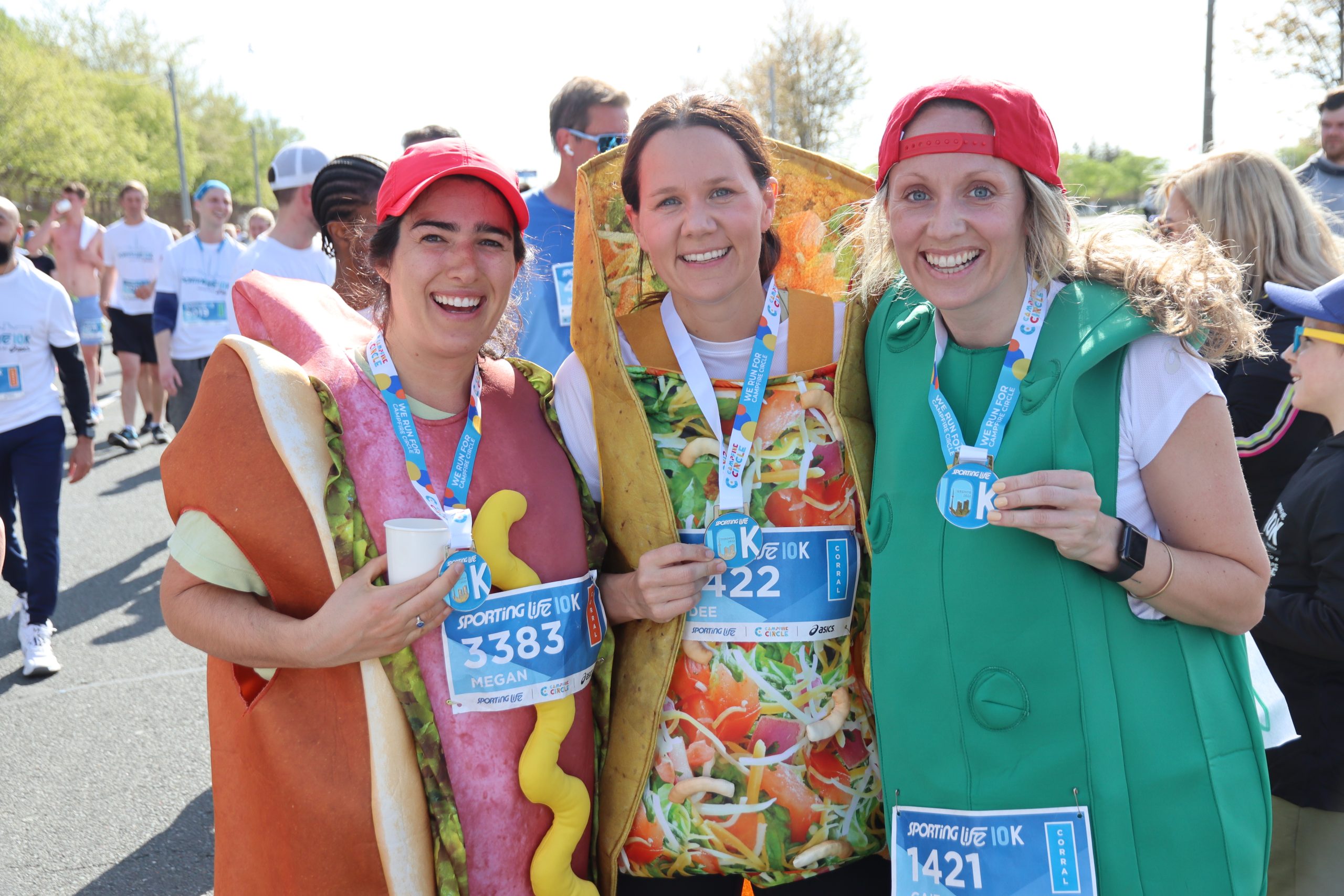 runners in costume showing off their medals