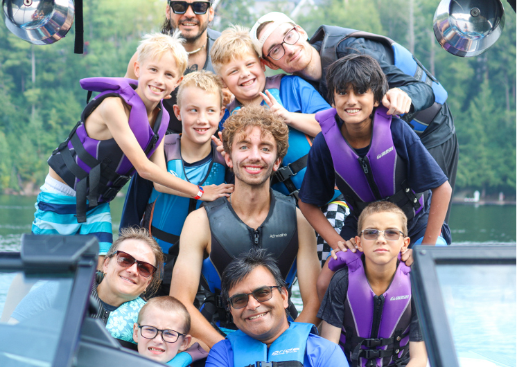 group of campers with volunteers wearing life jackets at camp